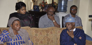 Minister of Information and Culture, Alhaji Lai Mohammed, condoles with Loretta, wife of the late Mr. Justin Abuja.