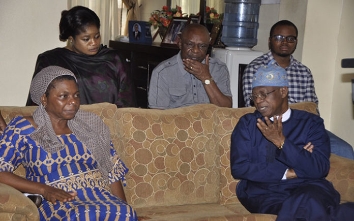 Minister of Information and Culture, Alhaji Lai Mohammed, condoles with Loretta, wife of the late Mr. Justin Abuja.