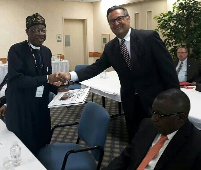 Minister of Information and Culture, Alhaji Lai Mohammed, receiving a souvenir from the CEO of Gates Air, Mr. Phil Argyris, when the Minister led a Nigerian delegation to the company in Quincy, US, on Tuesday