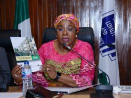 Permanent Secretary, Service Welfare Office, Mrs. Didi Walson-Jack displaying one of the FISH Handbooks during the meeting with FISH Developers in Abuja.JPG