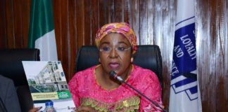 Permanent Secretary, Service Welfare Office, Mrs. Didi Walson-Jack displaying one of the FISH Handbooks during the meeting with FISH Developers in Abuja.JPG