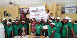 Officials of the Ministry in a group photograph with physically challenged beneficiaries.