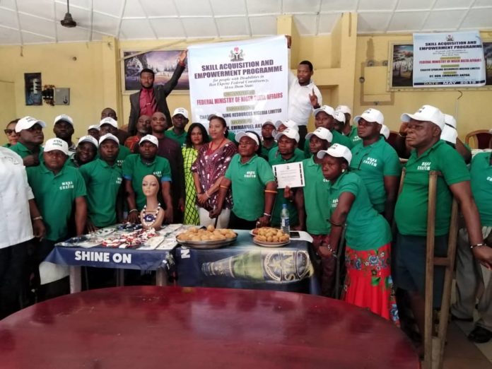 Officials of the Ministry in a group photograph with physically challenged beneficiaries.