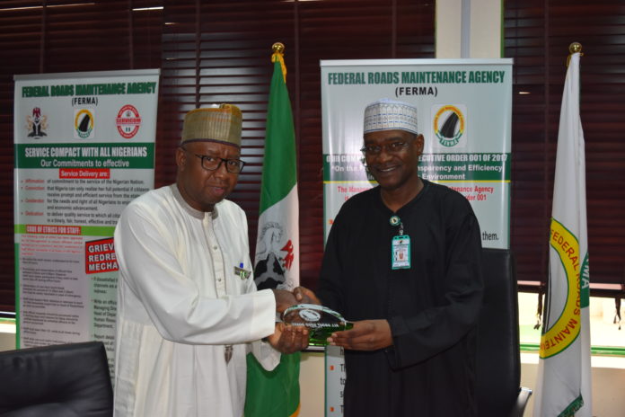 DSC_0239 R -L, MD/CEO, FERMA, Engr. Nuruddeen A. Rafindadi, FNSE, presenting crystal plaque to the Ag. MD/CEO, FHA Umar S. Gonto during FHA’s courtesy call to FERMA