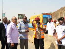 FCT Minister, Malam Muhammad Musa Bello, (4th left) listening to explanations from an FRSC official at the Gwarimpa U-Turn on the Outer Northern Expressway. with him is the Executive Secretary, FCDA engr Umar Gambo Jibrin (3rd left) and Task Team Chairman, Ikharo Attah (2nd left)