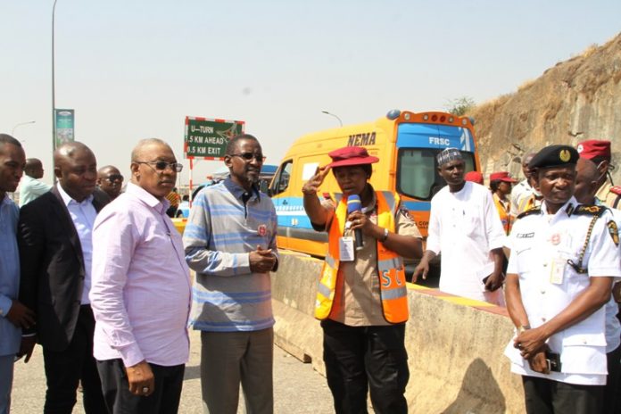 FCT Minister, Malam Muhammad Musa Bello, (4th left) listening to explanations from an FRSC official at the Gwarimpa U-Turn on the Outer Northern Expressway. with him is the Executive Secretary, FCDA engr Umar Gambo Jibrin (3rd left) and Task Team Chairman, Ikharo Attah (2nd left)