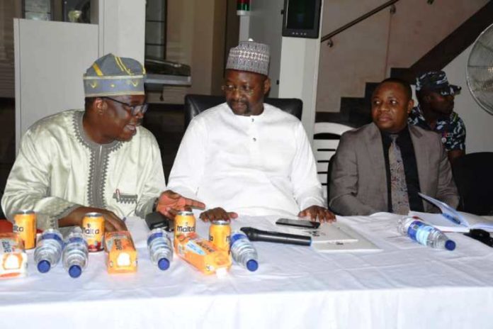 Middle:: Minister of Youth and Sports Devlpt; Hon. Sunday Dare; 1st Left is the Outgoing Permanent Secretary, FMYSD, Mr. Olusade Adesola; 1st Right is the incoming Permanent Secretary, FMYSD, Mr. Gabriel Tanimu Aduda during the Town Hall Meeting of the Ministry which held @ the Package A, MKO Abiola Stadium, Abuja.