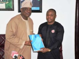 Occasion of the Handing Over-Ceremony at the Federal Ministry of Youth and Sports Development: Left is the Out-Going Permanent Secretary, Mr Olusade Adesola exchanging and releasing the Hand- Over Report to In- Coming Permanent Secretary, Mr Gabriel Tanimu Aduda, held today, Monday 23rd December, 2019.