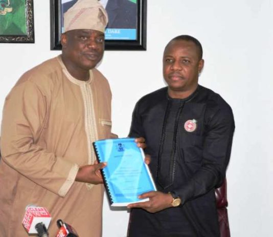 Occasion of the Handing Over-Ceremony at the Federal Ministry of Youth and Sports Development: Left is the Out-Going Permanent Secretary, Mr Olusade Adesola exchanging and releasing the Hand- Over Report to In- Coming Permanent Secretary, Mr Gabriel Tanimu Aduda, held today, Monday 23rd December, 2019.