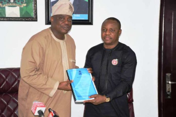 Occasion of the Handing Over-Ceremony at the Federal Ministry of Youth and Sports Development: Left is the Out-Going Permanent Secretary, Mr Olusade Adesola exchanging and releasing the Hand- Over Report to In- Coming Permanent Secretary, Mr Gabriel Tanimu Aduda, held today, Monday 23rd December, 2019.