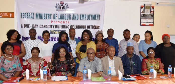 The representative of Permanent Secretary, Federal Ministry of Labour and Employment, Mr. Emmanuel Igbinosu (centre) flanked on the left by former Director Inspectorate Department of the Ministry Mrs. Amahian Jegbefumen and on the right by the Ag. Director, Inspectorate, Mr. Ajuwon Dauda and other participants of a Capacity Building workshop on Gender Mainstreaming in Workplace