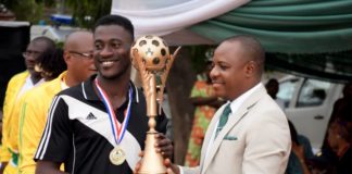 Permanent secretary, Mr. Gabriel Aduda presenting trophy to Enugu State NYSC football team
