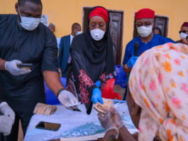 Middle; The Honourable Minister of Humanitarian Affairs, Disaster Management and Social Development, Hajiya Sadiya Umar Farouq, Right; Deputy Governor of Imo State, Prof. Placid Njoku during cash payment of N20,000 to one of the beneficiaries of the Conditional Cash Transfer Programme in Imo State at Iho, Ikeduru Local Government Area