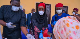 Middle; The Honourable Minister of Humanitarian Affairs, Disaster Management and Social Development, Hajiya Sadiya Umar Farouq, Right; Deputy Governor of Imo State, Prof. Placid Njoku during cash payment of N20,000 to one of the beneficiaries of the Conditional Cash Transfer Programme in Imo State at Iho, Ikeduru Local Government Area