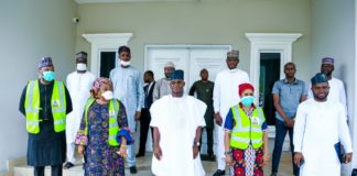 2nd Left; The representative of the Honourable Minister of Humanitarian Affairs, Disaster Management and Social Development (Head of Special Duties, of the Ministry, Nadia Muhammed-Soso) 3rd left; the Executive Governor of Kogi State, His Excellency, Yahaya Bello