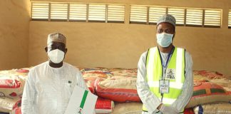 Left; The Representative of the Honourable Minister of Humanitarian Affairs, Disaster Management and Social Development Hajia Sadiya Umar Farouq, (Deputy Director, Disaster Management of the Ministry, Dr. Abubakar Suleiman), handing over food items as part of the COVID-19 pandemic palliatives to the Representative of the Katsina State Governor, His Excellency, Alhaji Aminu Bello Masari (The Special Adviser and Focal Person on Humanitarian Affairs, Alhaji Abubakar Nasir)
