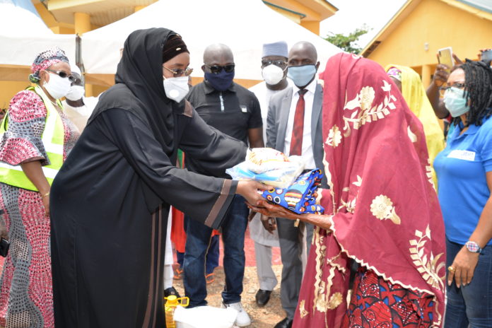DSC_1788 (Left) Honourable Minister of Humanitarian Affairs Disaster Management and Social Development, Sadiya Umar Farouq, presenting palliative to a beneficiary, during the flag-off for the distribution of relief materials to the Older Persons at Karshi, Abuja, over the weekend.