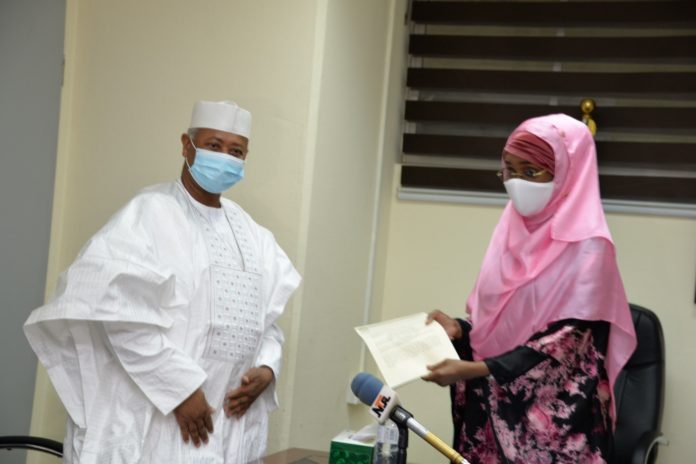 PEF (Right) The Honourable Minister of Humanitarian Affairs, Disaster Management and Social Development, Sadiya Umar Farouq receiving letter of Covid-19 palliative from the Executive Secretary Petroleum Equalisation Fund, Ahmed Bobboi.