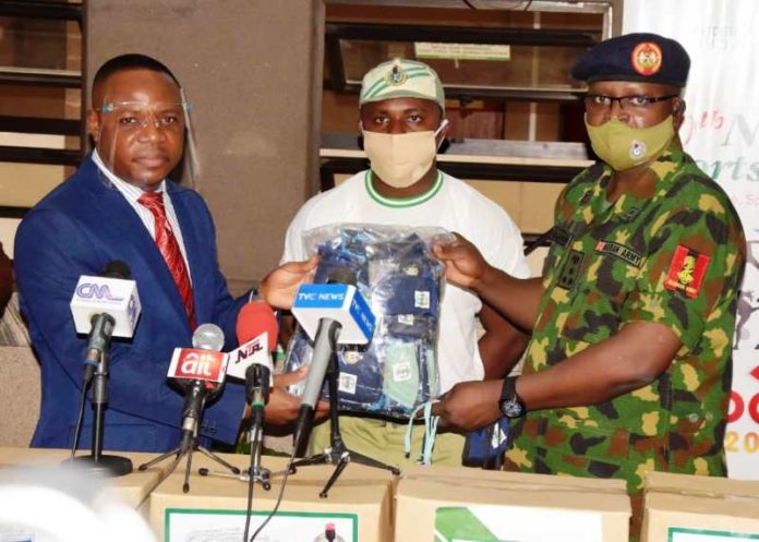 Left to Right is Mr Gabriel Aduda, Permanent Secretary of the Ministry, representing the Hon. Minister at the event; Dr. Vincent Chidera, Corps Member & Leader of Team that produces the Face Mask & the D.G NYSC, Brig.Gen. Ibrahim Shuaibu; during its Launching at the Foyer Hall of the Ministry