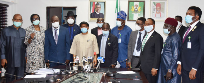 The Honoruable Minister Labour and Employment, Chris Ngige (4th left), Permanent Secretary, Labour and Employment, William Alo (3rd left), President, Nigeria Medical Association (NMA), Prof. Innocent Ujah (5th left), in a group photograph with the Executive members of NMA and the Directors in the Ministry.