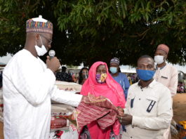 (Left) The Director Overseeing Office of the Permanent Secretary, Grema Ali Alhaji, during the handing over of food and non-food items to the Heads of the Internally Dispalced Person's camp, Hafast Hammad (Middle), and Joffery Bitrus (Right)