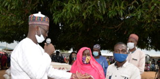 (Left) The Director Overseeing Office of the Permanent Secretary, Grema Ali Alhaji, during the handing over of food and non-food items to the Heads of the Internally Dispalced Person's camp, Hafast Hammad (Middle), and Joffery Bitrus (Right)