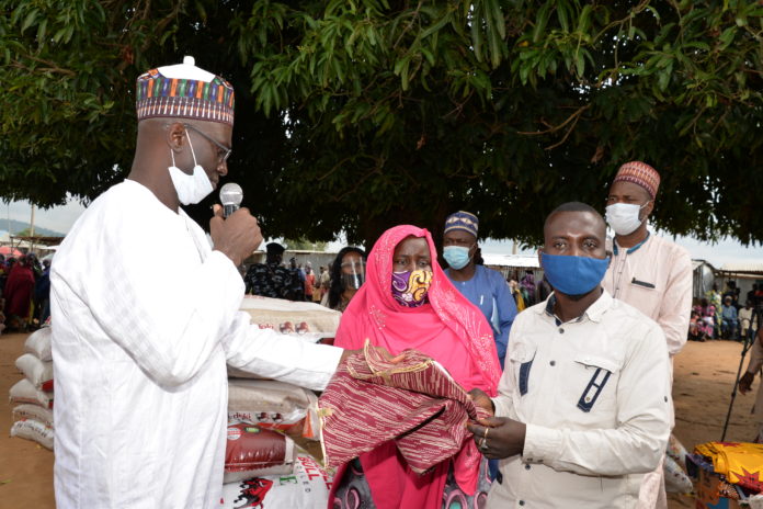DSC_8042 (Left) The Director Overseeing Office of the Permanent Secretary, Grema Ali Alhaji, during the handing over of food and non-food items to the Heads of the Internally Dispalced Person's camp, Hafast Hammad (Middle), and Joffery Bitrus (Right)