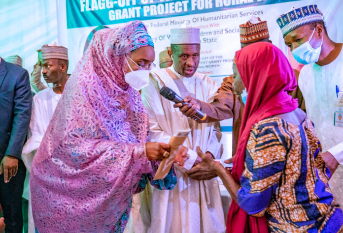 L; The Honourable Minister of Humanitarian Affairs, Disaster Management and Social Development Sadiya Umar Farouq, Middle; Secretary to the State Government [SSG], Alhaji Bala Bello, and R; one of the beneficiary during the flagg off for the Federal Government Grant for Rural Women in Gusau, Zamafar State. October 27, 2020