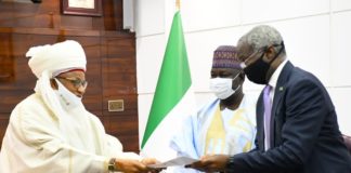 Chairman Niger Council of Traditional Rulers & the Etsu of Nupe ,His Royal Highness, Dr. Yahaya Abubakar handing over his presentation to Honourable Minister of Works and Housing , Babatunde Raji Fashola and Honourable Minister of State for Works and Housing , Abukar D Aliyu during his courtesy visit to the Ministry of Works and Housing Headquarters in Abuja