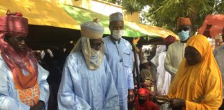 (2nd Right), Representative of the Minister of Humanitarian Affairs, Deputy Director Humanitarian Affairs, Dr. Sulieman Abubakar, (3rd Right) Representative of the Emir of Katagum, Alhaji Aliyu Hussaini, presenting grant to a beneficiary during the flag off of the Federal government Grant for Rural Women Project in Katagum, Bauchi State.