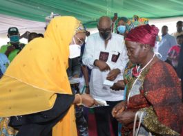 (left) Honourable Minister of Humanitarian Affairs, Disaster Management and Social Development, Sadiya Umar Farouq, the Executive Governor of Ondo State, Arakunrin Oluwarotimi Akeredolu, presenting Federal Government Special Cash Grant for Rural Women Programme to a beneficiary, during the flag off ceremony of the programme in Akure, Ondo State, 26th November, 2020. Photo by Khalid Ahmed