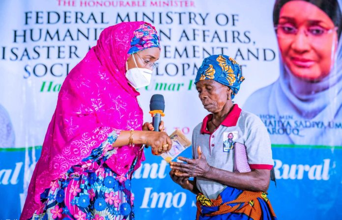 Left; The Honourable Minister of Humanitarian Affairs, Disaster Management and Social Development, Sadiya Umar Farouq, presenting the Cash of N20,000 to one of the beneficiaries, Mrs Mary Ajanogwu from Idiako South Local Government Area of Imo State, during the Flag off of the Federal Government Special Grant for Rural Women at Ajokwu Convention Centre, in Owerri, Imo State, December 3, 2020.