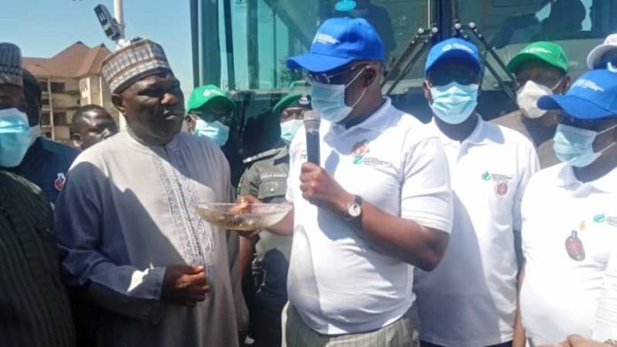 The Minister of State, Petroleum Resources presenting keys of CNG powered Mass Transit Buses to organized Labour