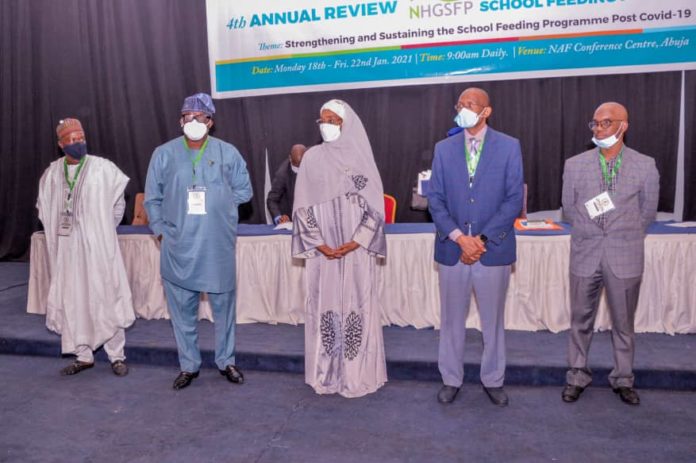 IMG-20210118-WA0000 (Middle) The Honourable Minister of Humanitarian Affairs, Disaster Management and Social Development, Sadiya Umar Farouq, (2nd Right) The Permanent Secretary of the Ministry, Bashir Nura Alkali, (1st Right) S.A to the President on National Social Investment Programme (NSIP), Dr Mohammed Nasir Mahmoud, (1st Left), Senior Special Adviser to The Honourable Minister of Humanitarian Affairs, Disaster Management and Social Development, Dr. Engr. Umar Bindu, (2nd Left), State Focal Person Ekiti State, Victor Kolade, during the 4th Annual Review of the National Home Grown School Feeding Programme, held at NAF Centre, Abuja, on the 18th January, 2021.