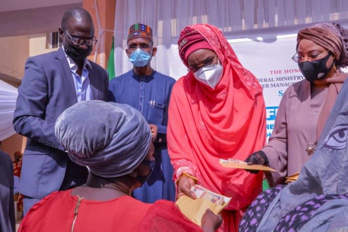 IMG-20210121-WA0001 2nd Right) The Honourable Minister of Humanitarian Affairs, Disaster Management and Social Development, Sadiya Umar Farouq,(1st Right) Minister of State for FCT, Dr. Ramatu Tijjani Aliyu (2nd Left) the Permanent Secretary of the Ministry, Bashir Nura Alkali, (1st Left) Director Humanitarian Department, Grema Ali Alhaji, and a Beneficiary, Ruth Kadiri during the Flag - Off of the Federal Government Cash Grant For Rural Women in FCT, on 21st January, 2021. Abuja. Photo: Khalid Ahmed.