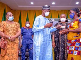 (Middle) Representative of the Honourable Minister of Humanitarian Affairs, Disaster Management and Social Development, the Permanent Secretary of the Ministry, Bashir Nura Alkali, (2nd Right) Representative of the Deputy Governor of Anambra State, Commissioner Social Welfare, Women and Children Affairs, Ndidi Mezue , (1st Left) Director Special Needs, Mrs Nkechi Onwukwe (1st Right) a Beneficiary, Mrs Caroline, during the Federal Government Special Grant for Rural Women in Anambra State, at Professor Dora Akunyili Women Development centre Awka. On the 31st January, 2021. Photo: Khalid Ahmed.