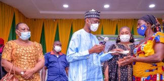 (Middle) Representative of the Honourable Minister of Humanitarian Affairs, Disaster Management and Social Development, the Permanent Secretary of the Ministry, Bashir Nura Alkali, (2nd Right) Representative of the Deputy Governor of Anambra State, Commissioner Social Welfare, Women and Children Affairs, Ndidi Mezue , (1st Left) Director Special Needs, Mrs Nkechi Onwukwe (1st Right) a Beneficiary, Mrs Caroline, during the Federal Government Special Grant for Rural Women in Anambra State, at Professor Dora Akunyili Women Development centre Awka. On the 31st January, 2021. Photo: Khalid Ahmed.