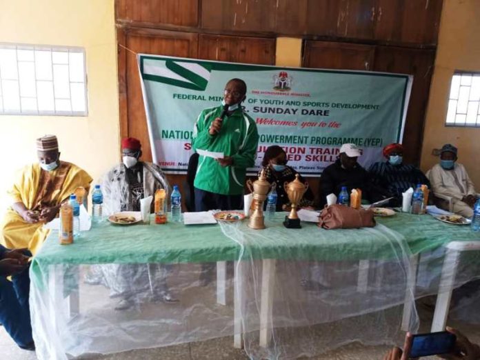 ccasion of the Closing Ceremony of the National Youth Empowerment On Sustainable Livelihood Programme In Agriculture for Unemployed Youth at the National Youth Development Centre, Shere Hills, Jos-Plateau State on 19th Feb 2021. 3rd Left: Representative of the Hon. Minister of Youth & Sports Development, Mr Emmanuel Essien, ( Deputy Director in the Ministry) delivering the speech of the Hon. Minister to participants/ trainees