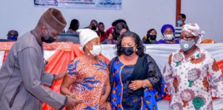 (1st Left) The Representative of the Honourable Minister of Humanitarian Affairs, Disaster Management and Social Development, Sadiya Umar Faro'uq, Director Humanitarian Affairs, Grema Ali Alhaji, (2nd Right) The Representative of the Governor of Delta State, Honourable Commissioner of Women Affairs, Mrs Florence Alatan, (1st Right) Focal person National Social Investment Programme (NSIP) Delta State, Barr. Bridget Anyafulu, (2nd Left) a Beneficiary of the Grant, a woman with disability, Edore Akpofure, during the disbursement of the Federal Government Cash Grant for Rural Women in Delta State, on 23rd March, 2021