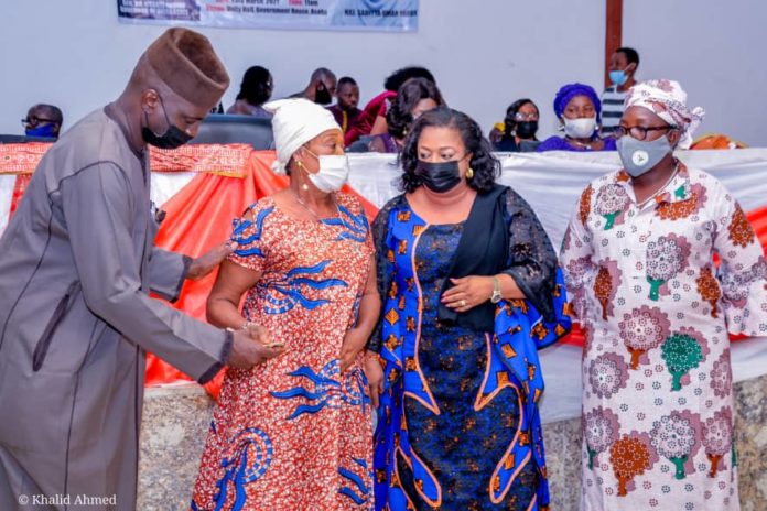 IMG-20210323-WA0000 (1st Left) The Representative of the Honourable Minister of Humanitarian Affairs, Disaster Management and Social Development, Sadiya Umar Faro'uq, Director Humanitarian Affairs, Grema Ali Alhaji, (2nd Right) The Representative of the Governor of Delta State, Honourable Commissioner of Women Affairs, Mrs Florence Alatan, (1st Right) Focal person National Social Investment Programme (NSIP) Delta State, Barr. Bridget Anyafulu, (2nd Left) a Beneficiary of the Grant, a woman with disability, Edore Akpofure, during the disbursement of the Federal Government Cash Grant for Rural Women in Delta State, on 23rd March, 2021