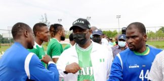Hon. Minister of Youth & Sports Devlpt. Chief Sunday Dare exchanging pleasantries with team Kano players before the commencement of Male Handball Match during the Edo 2020 Games, 20th National Sports Festival @ Benin City, Edo State