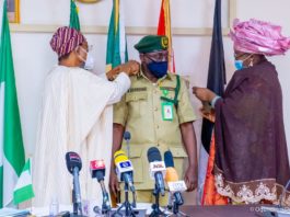 HMI Ogbeni Rauf Aregbesola (Left), joined by the Spouse of the new CG, Hajia Shafa'atu Haliru Nababa while decorating Nababa as new CG, NCoS in Abuja on Monday.