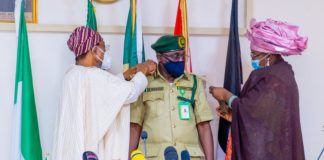 HMI Ogbeni Rauf Aregbesola (Left), joined by the Spouse of the new CG, Hajia Shafa'atu Haliru Nababa while decorating Nababa as new CG, NCoS in Abuja on Monday.