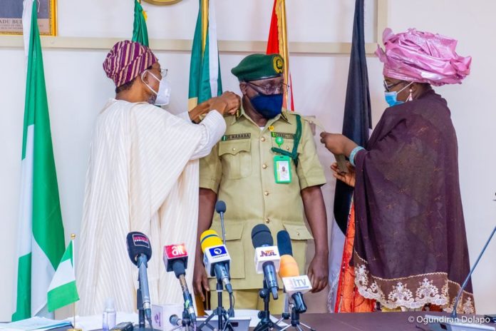 HMI Ogbeni Rauf Aregbesola (Left), joined by the Spouse of the new CG, Hajia Shafa'atu Haliru Nababa while decorating Nababa as new CG, NCoS in Abuja on Monday. HMI Ogbeni Rauf Aregbesola (Left), joined by the Spouse of the new CG, Hajia Shafa'atu Haliru Nababa while decorating Nababa as new CG, NCoS in Abuja on Monday.