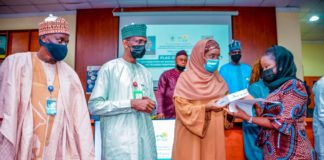 (3rd Left) The Honourable Minster of Humanitarian Affairs, Disaster Management and Social Development, Sadiya Umar Farouq, (2nd Left) the Permanent Secretary of the Ministry, Bashir Nura Alkali, (1st Left) National Coordinator for NSIP, Engr. Umar B. Bindir, (1st Right) an Independent Monitor, Aisha H. Ihiabe, during the Flag - Off, of the distribution of engagement letters and monitoring devices to Independent Monitors, on 10th June, 2021, in Abuja. Photo: Khalid Ahmed.
