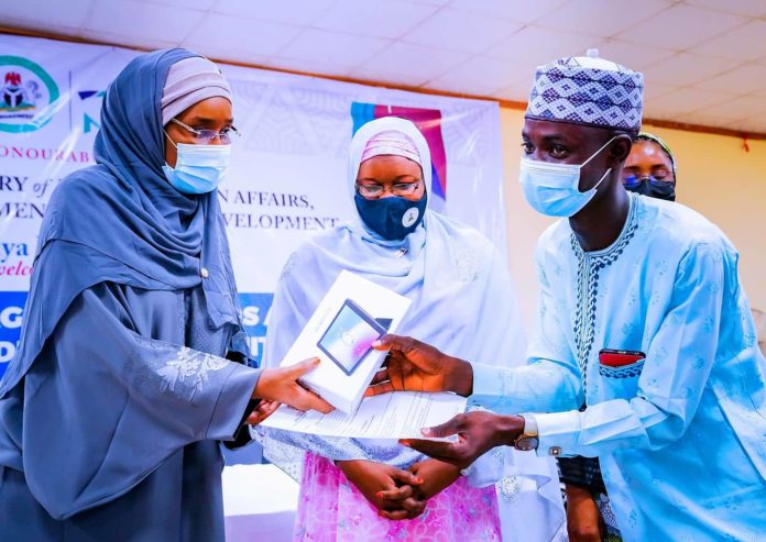 IMG-20210615-WA0001 (Left) Honourable Minister of Humanitarian Affairs, Disaster Management and Social Development, Sadiya Umar Farouq, (Middle) Bauchi State Focal Person, Amina Katagum, presenting letter of engagement and monitoring device to a trained Independent Monitor, during the flag off ceremony in Bauchi State, 14th June, 2021.