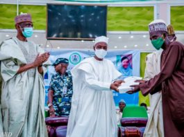 (Left) The Representative of the Honourable Minster of Humanitarian Affairs, Disaster Management and Social Development,Sadiya Umar Farouq, the Permanent Secretary of the Ministry, Bashir Nura Alkali, (middle) The Representative of the Government of Kano State, SSG Usman Waziru Gaya, (Right) an Independent Monitor, during the distribution of engagement letters and monitoring devices to Independent Monitors in Kano State, on the 15th June, 2021. In Kano.