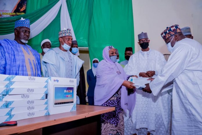 IMG-20210629-WA0000 4th Left) The Representative of the Honourable Minster, Federal Ministry of Humanitarian Affairs, Disaster Management and Social Development, Sadiya Umar Farouq, the Permanent Secretary of the Ministry, Bashir Nura Alkali, (3rd Left) The Representative of Sokoto State Governor, Hajiya Kulu Abdullahi Sifawa, (2nd Left) Focal Person NSIP for Sokoto State, Hayatu Tafida, during the distribution of engagement letters and monitoring devices to Independent Monitors in Sokoto State, on 28th June 2021. In Sokoto.