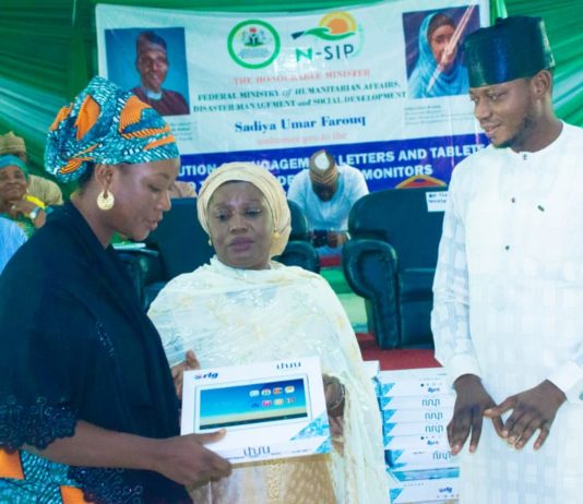 (middle) Representative of the Honourable Minister of Humanitarian Affairs, Disaster Management and Social Development, Sadiya Umar Farouq, the Deputy Director, Planning, Research and Statistics of the Ministry, Safiya Sani, (Right) Kogi State Focal Person on NSIP, Abdulkareem Suleiman, presenting engagement letter and tablet to (left) trained Independent Monitor, Mummy Rekiya Mohammed, during the flag off ceremony of the distribution of engagement letters and tablets to trained Independent Monitors in Kogi State, Wednesday June 30th, 2021