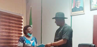 Honourable Minister of State, Labour and Employment, Festus Keyamo, receiving the report of the Panel of Inquiry set up to investigate the death of Richard Gbadebo, from Chairman of the Panel and Director Occupational Safety and Health, Lauretta Nneka Adogu in Abuja